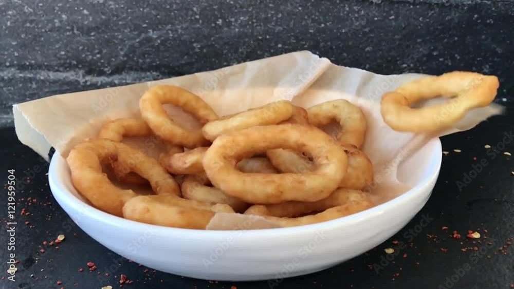 Golden crispy Onion rings coated with breadcrumbs and deep fried flying slow motion.
Golden crispy Onion rings coated with breadcrumbs and deep fried flying slow motion.