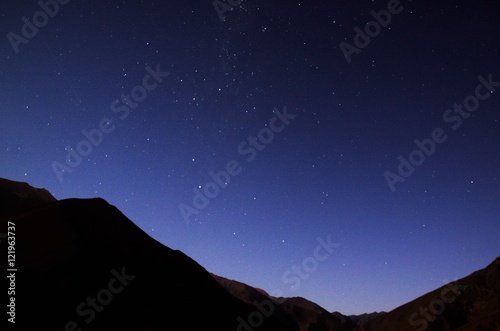 Stargazing in Elqui Valley with hundreds of stars in the sky between black hills in Chile, South America photo