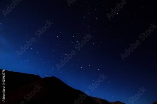 Stargazing in Elqui Valley with hundreds of stars in the sky between black hills in Chile, South America © mandy2110