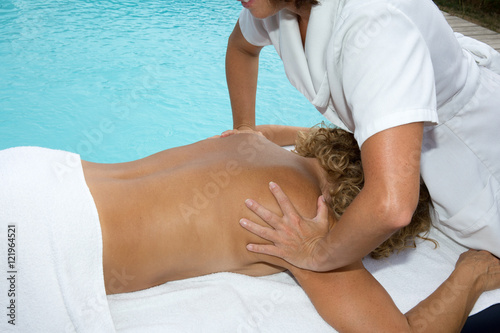 Blond woman relaxing with hand massage at beauty spa, closeup