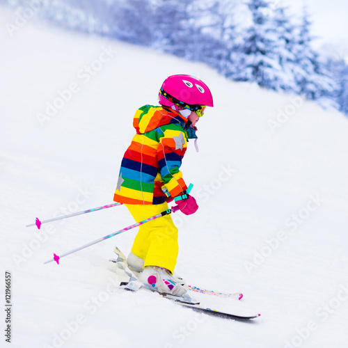 Little girl skiing in the mountains