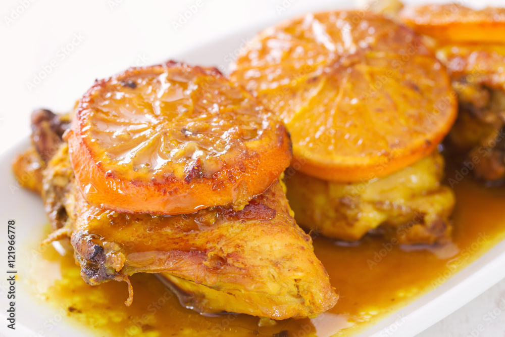 fried chicken with orange on white dish fried chicken with orange on white dish