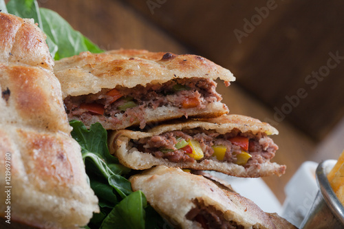 An Egyptian food  hawawshi is a  classic of spiced meat baked in  bread served with tahina