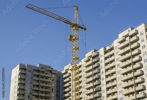 Monolithic concrete buildings and the construction crane.