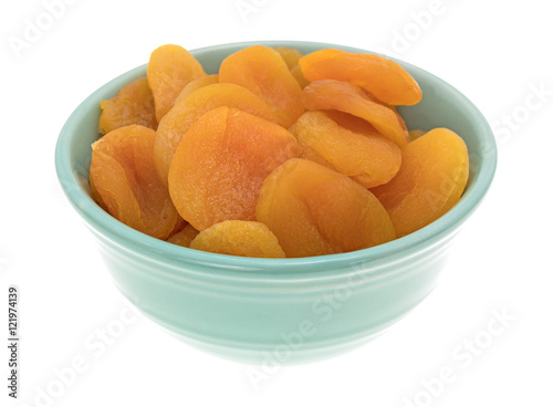 Dried apricots in a green bowl