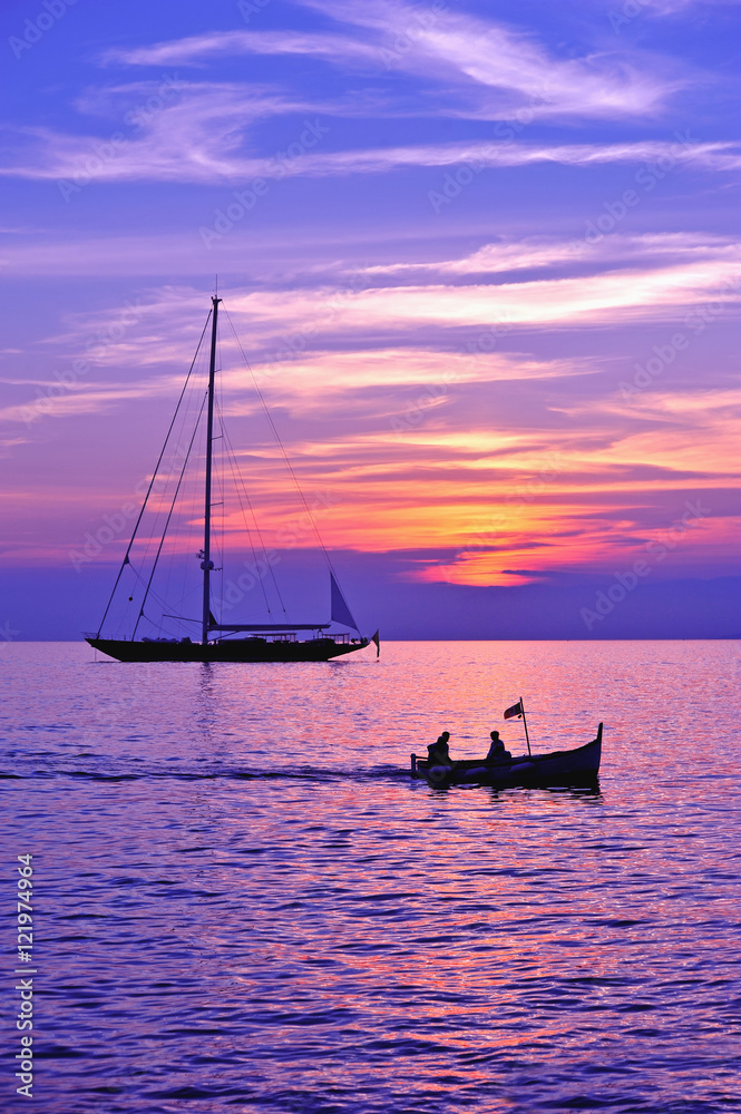 Fototapeta premium purple sky with boat and sailing ship silhouette