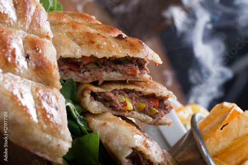 An Egyptian food  hawawshi is a  classic of spiced meat baked in  bread served with tahina