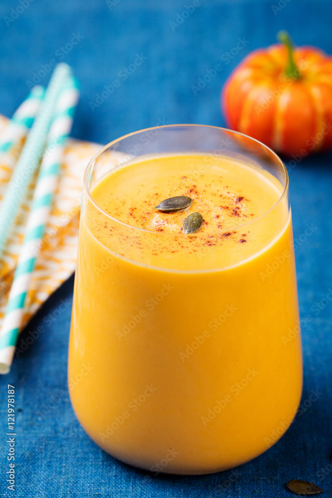 Pumpkin smoothie with pumpkin pie spices on a blue wooden background Pumpkin smoothie with pumpkin pie spices on a blue wooden background