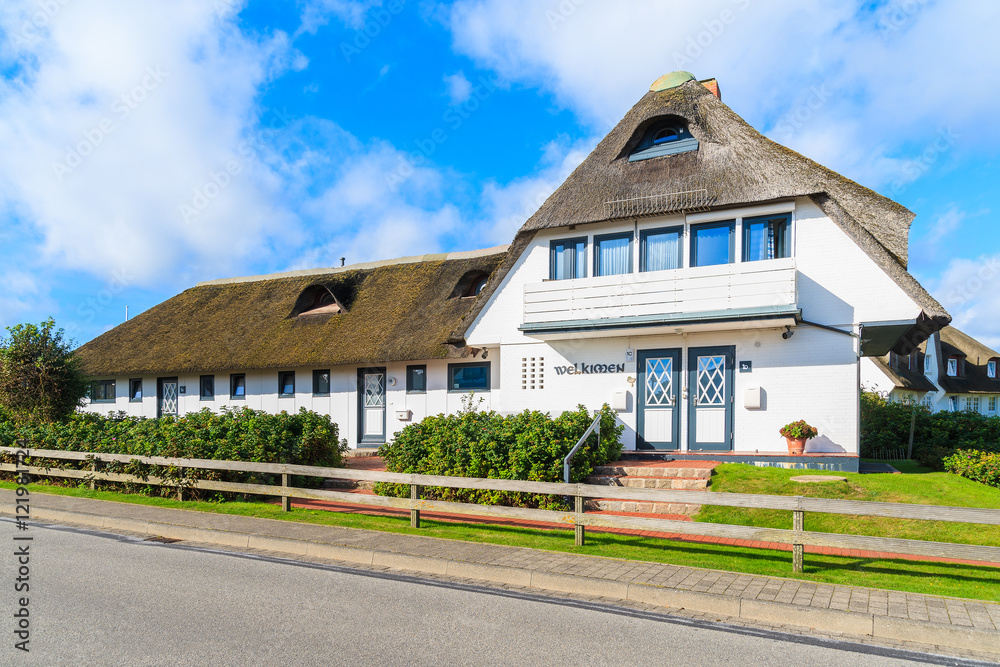 Typical Frisian guest house with thatched roof on Sylt island in Wenningstedt village, Germany