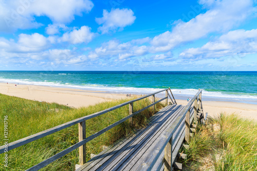 Wooden footbridge from sand dune to beautiful beach near Westerland village, Sylt island, Germany © pkazmierczak
