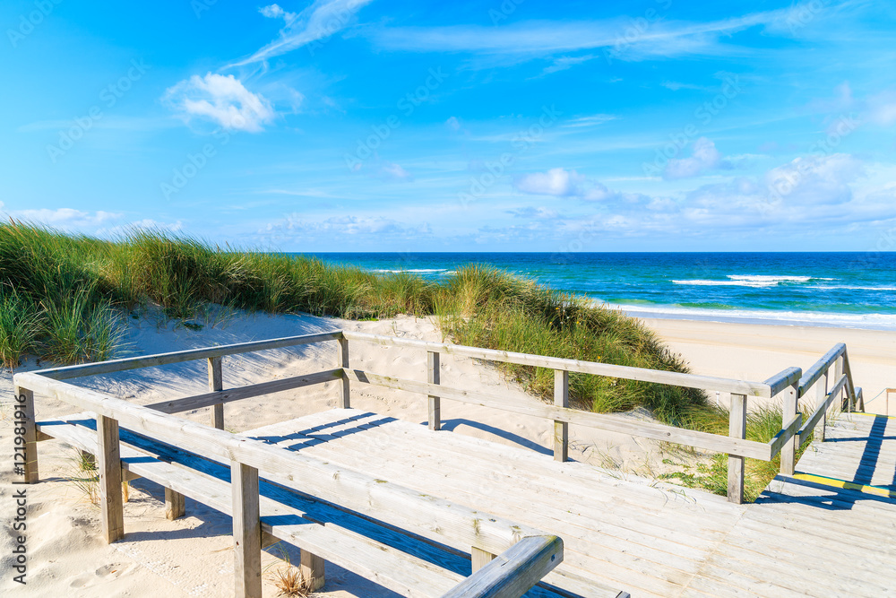 Wooden platform with view of idyllic sandy beach on Sylt island, Germany