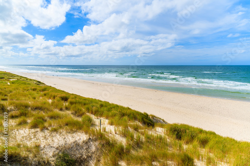 Grass on sand dune and view of beach in List village, Sylt island, Germany