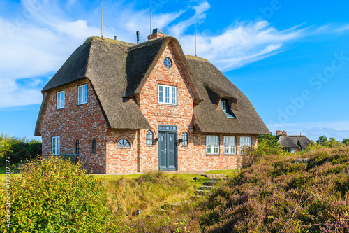 Photos Traditional red brick house with thatched roof in Kampen village on Sylt island,