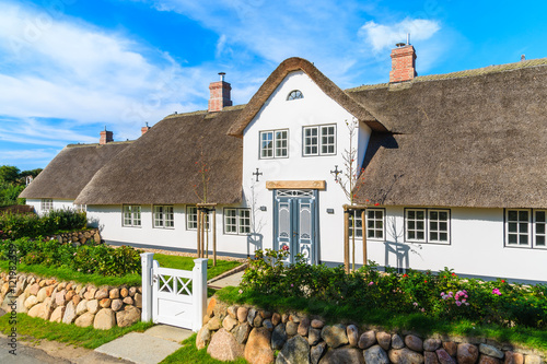 Traditional white house with thatched roof in Wenningsted village on Sylt island, Germany