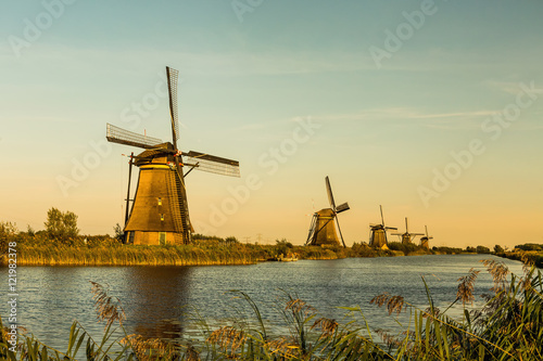 Windmills of Kinderdijk near Rotterdam in Netherlands. Colorful spring scene in the famous Kinderdijk canals with windmills, UNESCO world heritage site