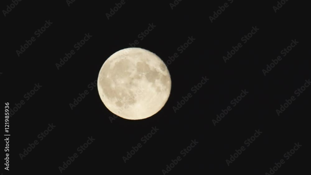 full moon with relief elements quickly rises in the black sky full moon with relief elements quickly rises in the black sky