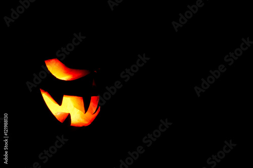 very scary Halloween pumpkin isolated on black background with i
