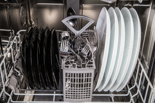 Dishes after washing in modern dishwasher machine