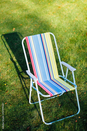 garden chair on green lawn background