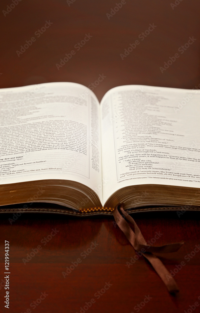 Holy Bible Open on a Wooden Table Holy Bible Open on a Wooden Table