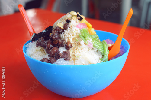ice kacang or ais kacang (ABC) in Malay language, a colorful Malaysian dessert made of shaved ice, beans and colorful jelly. photo