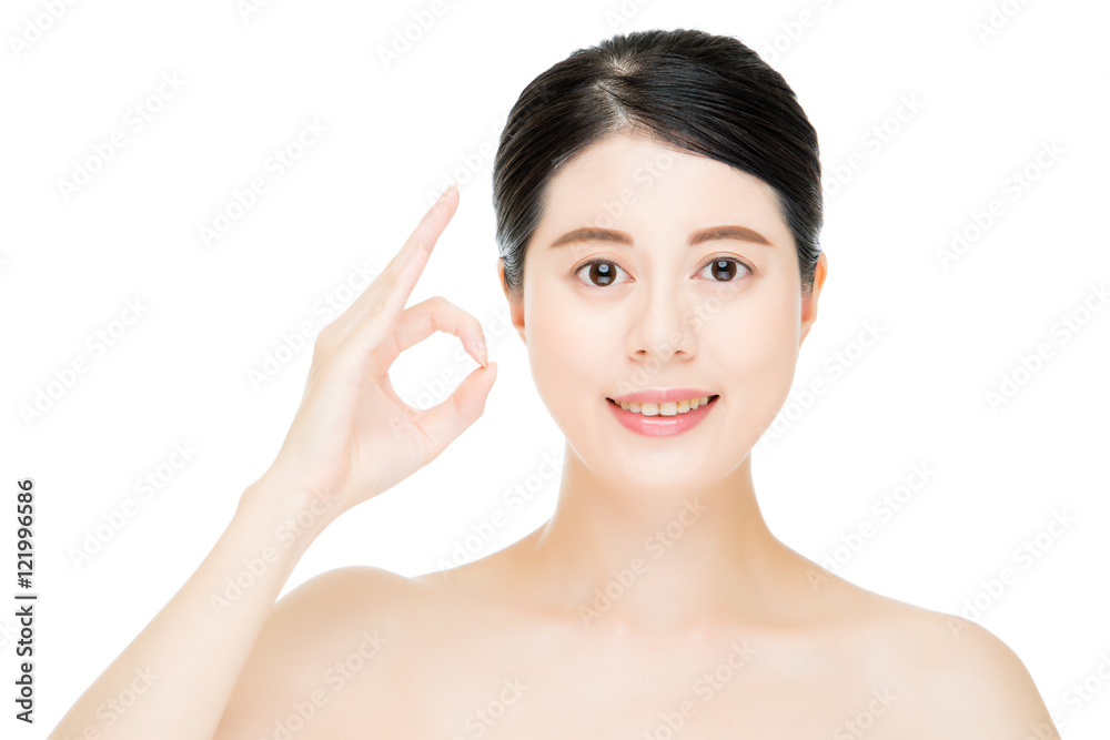 Close up of young smiling woman with finger ok gesture