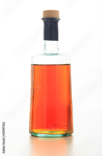 Bottle of vinegar on white background