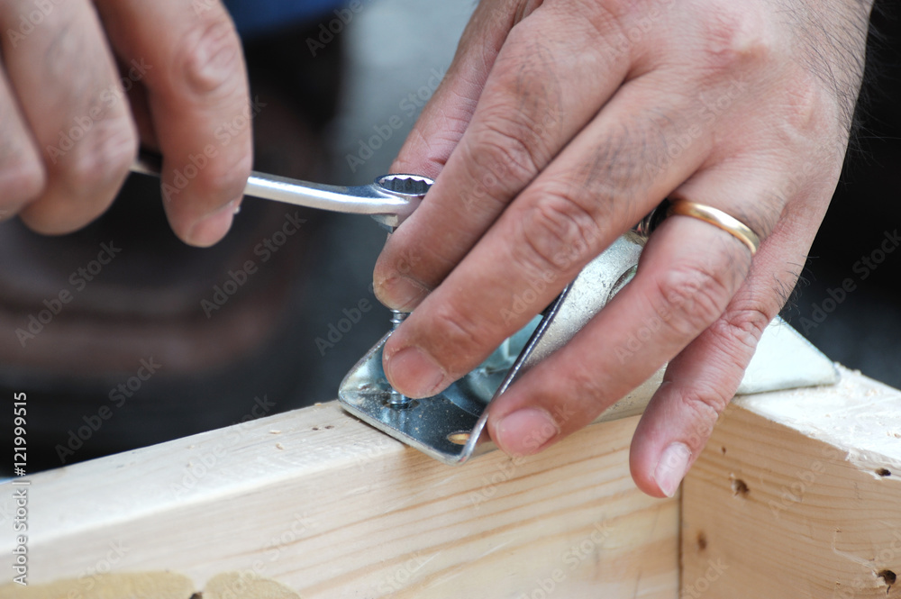 handyman working on the project with wrench handyman working on the project with wrench