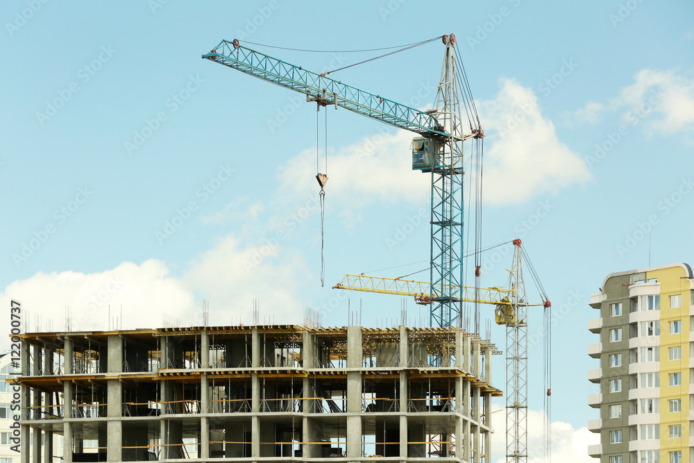 Crane and building construction on sky background Crane and building construction on sky background