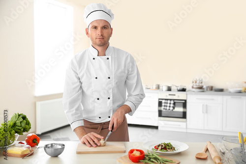 Young chef cook cutting mus...