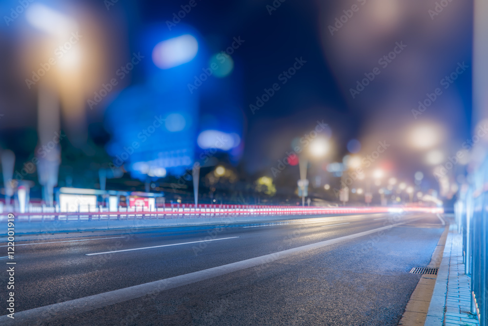 blurred traffic light trails on road at night in China.