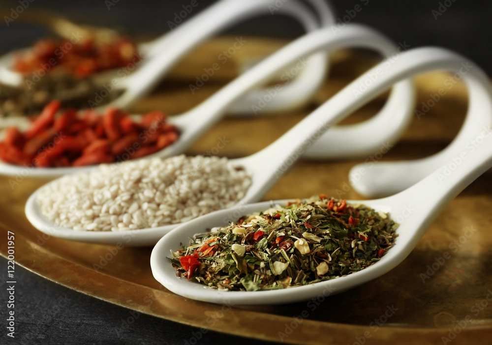 Different spices in spoons on tray Different spices in spoons on tray