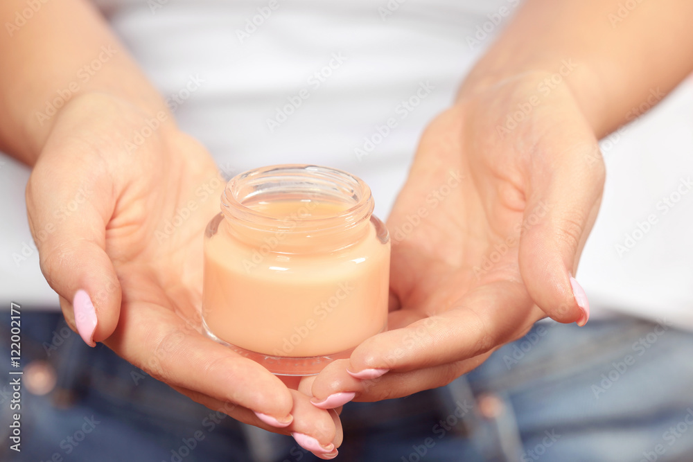 Jar of cream in female hands, close up Jar of cream in female hands, close up
