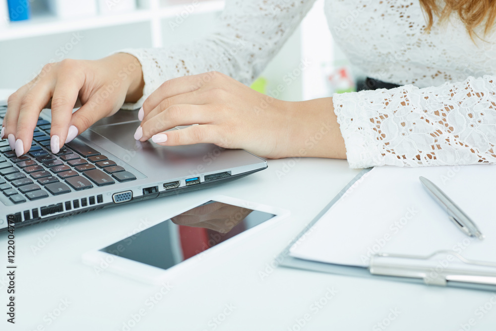 Closeup of a female hands busy typing on a laptop. Closeup of a female hands busy typing on a laptop.