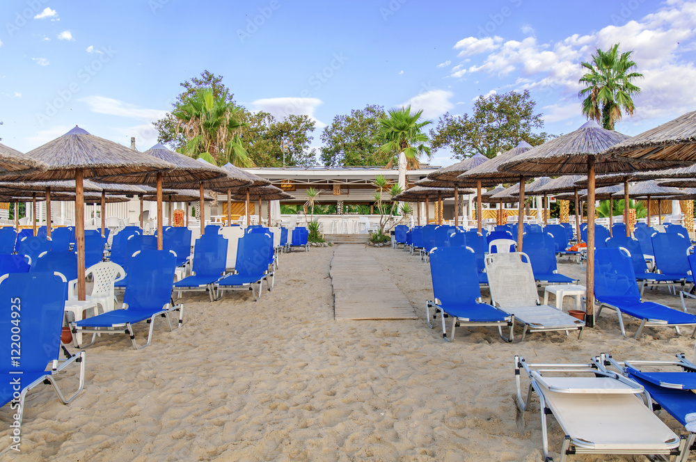 ASPROVALTA, GREECE - AVGUST 28, 2016: Beach bar Splash with lot sunbeds and sky background in Asprovalta ASPROVALTA, GREECE - AVGUST 28, 2016: Beach bar Splash with lot sunbeds and sky background in Asprovalta