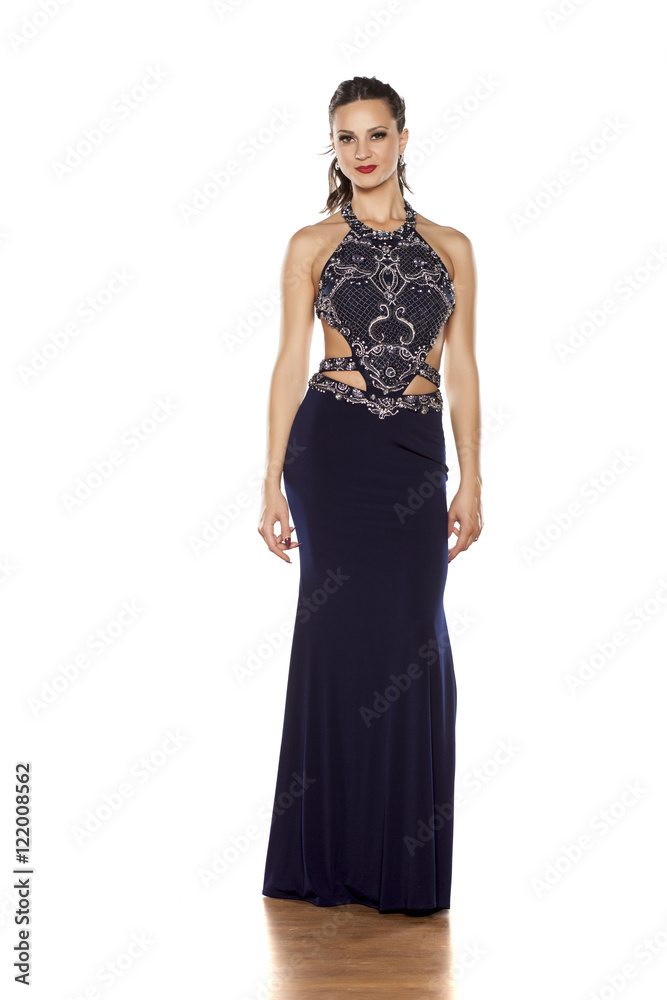 young beautiful woman posing in a long blue dress on a white background young beautiful woman posing in a long blue dress on a white background