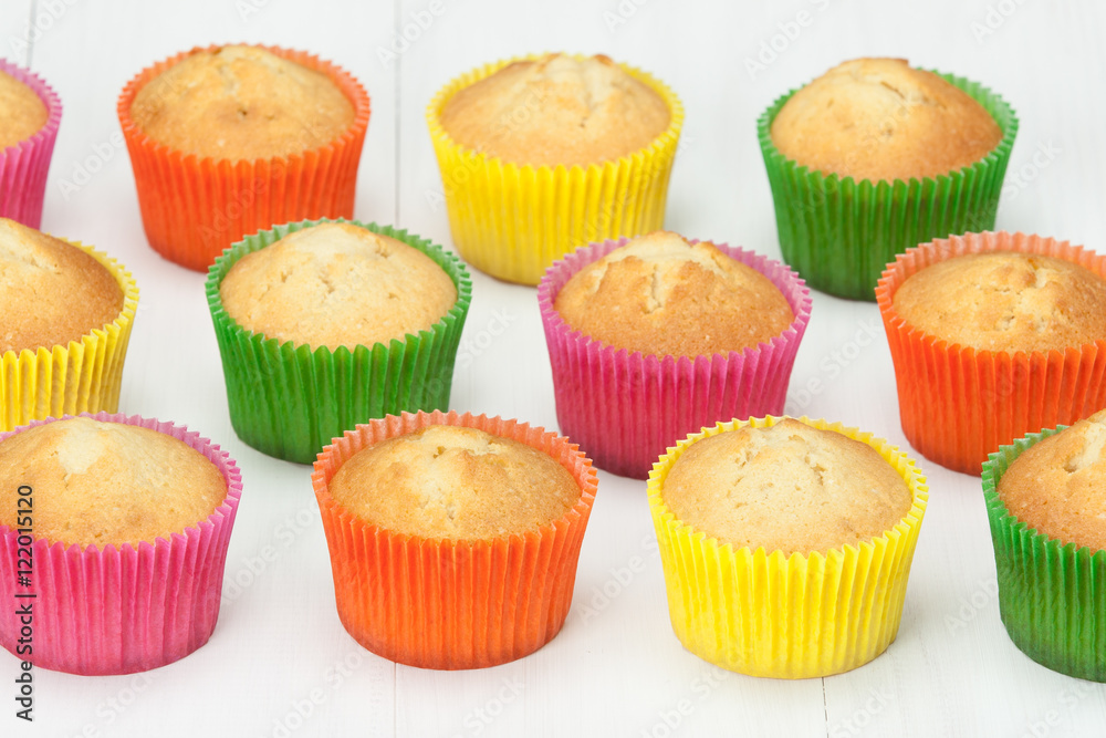 Homemade Colorful Plain Cupcakes On White Table. Homemade Colorful Plain Cupcakes On White Table.