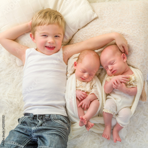 Happy brother with twin babies