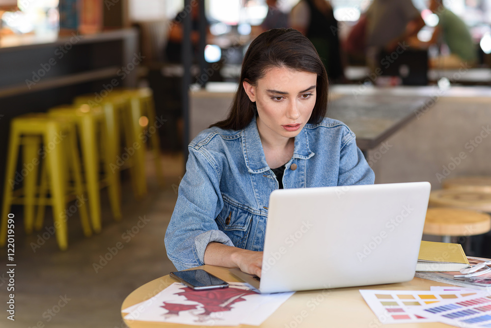 designer working while sitting in a cafe