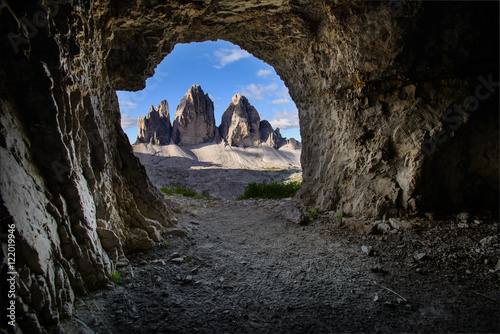 View of Tre Cime from a cave. Interesting perspective of a famous mountain in dolomites. Italy. Hiking paradise. Mountaineering. Vacation in Europe