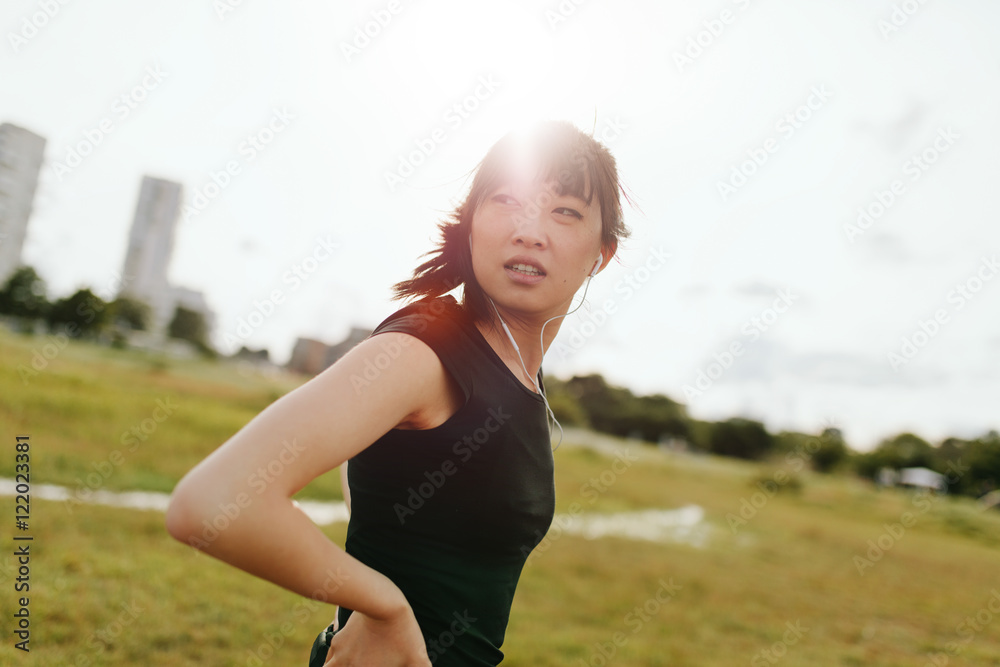 Fitness female on field glancing back Fitness female on field glancing back