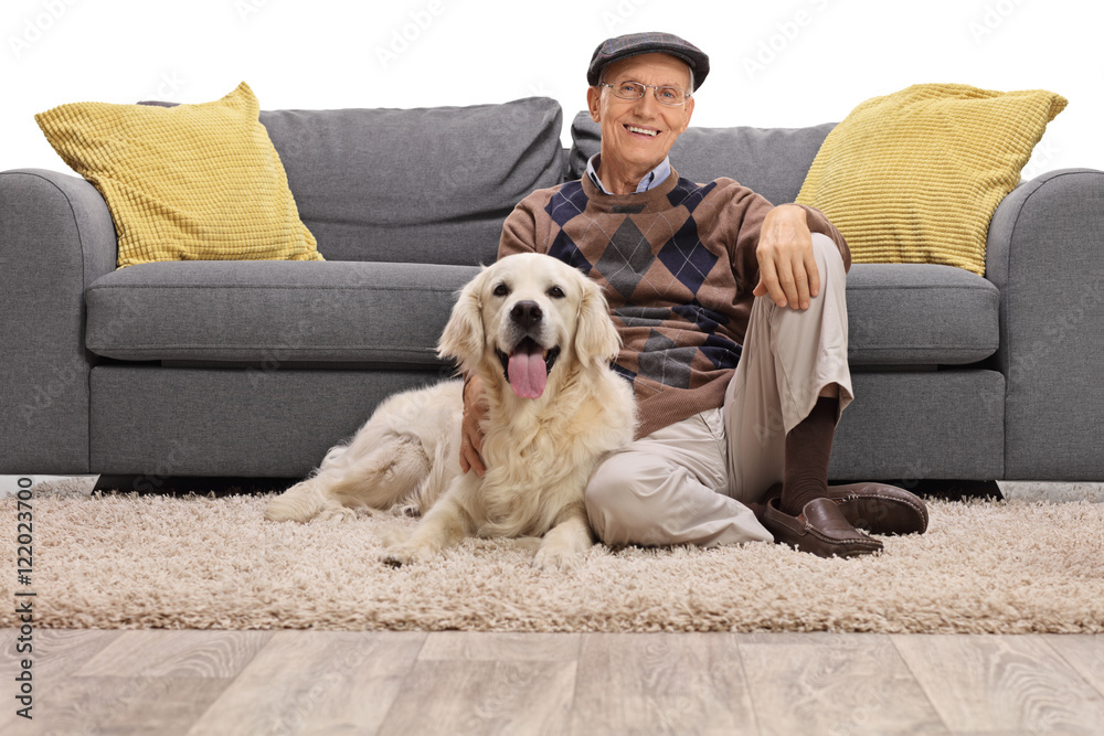 Mature man sitting on the floor with his dog Mature man sitting on the floor with his dog