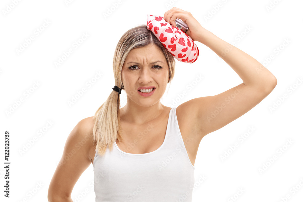 Woman holding an ice pack on her head Woman holding an ice pack on her head
