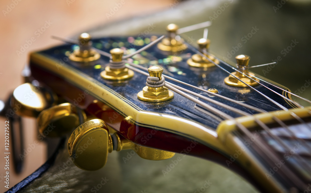 Fototapeta premium Red acoustic guitar close up in dark background
