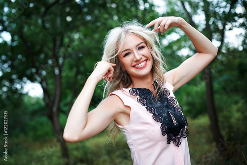 woman with long blond hair posing in summer park © timonko