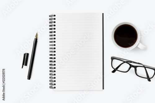 Blank notebook on top of white office desk table with supplies.