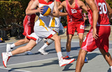 Basketball players in action outdoors