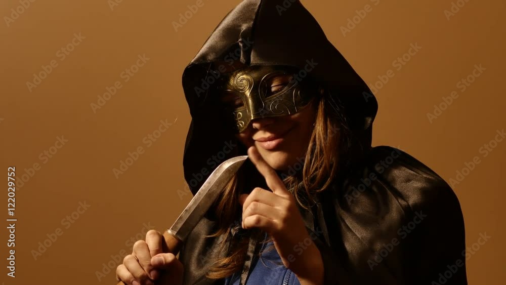 Portrait of a horror Halloween model - satanic teen girl priest or ...