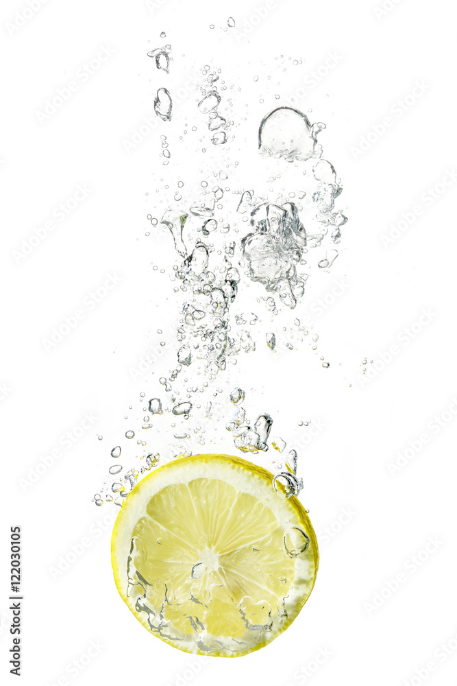 lemon slice dropped into water with bubbles