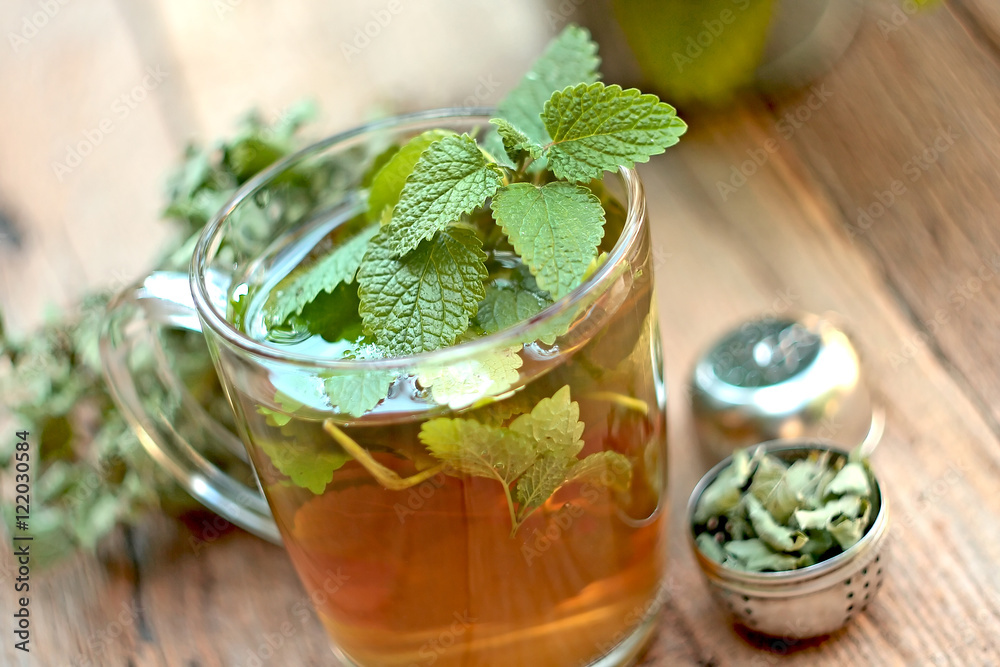 A cup of melissa tea on wooden background
A cup of melissa tea on wooden background
